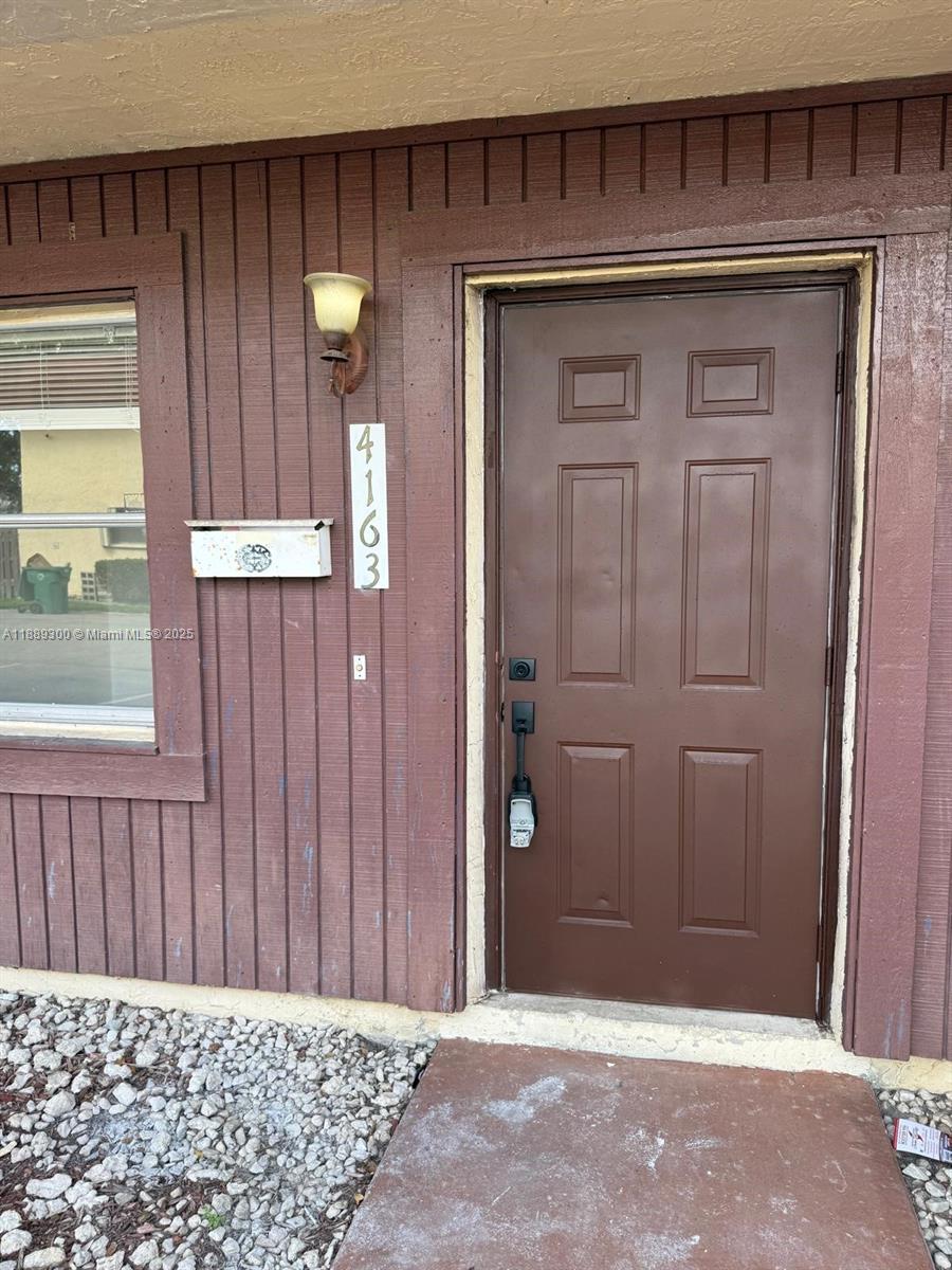 a view of a door and a wooden door