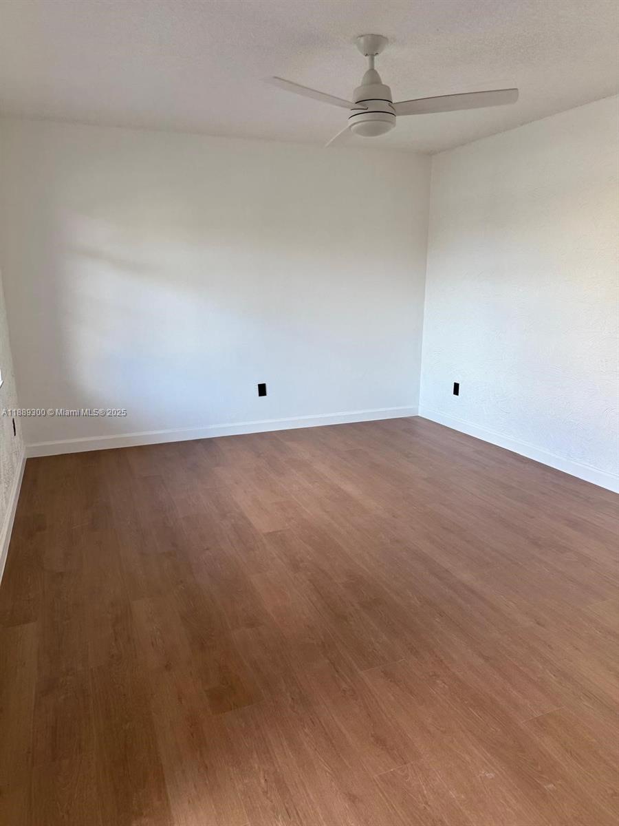 4163 Southwest 66th Terrace, Unit 108 Davie, FL 33314 - Photo 7 of 15 an empty room with a ceiling fan and carpet