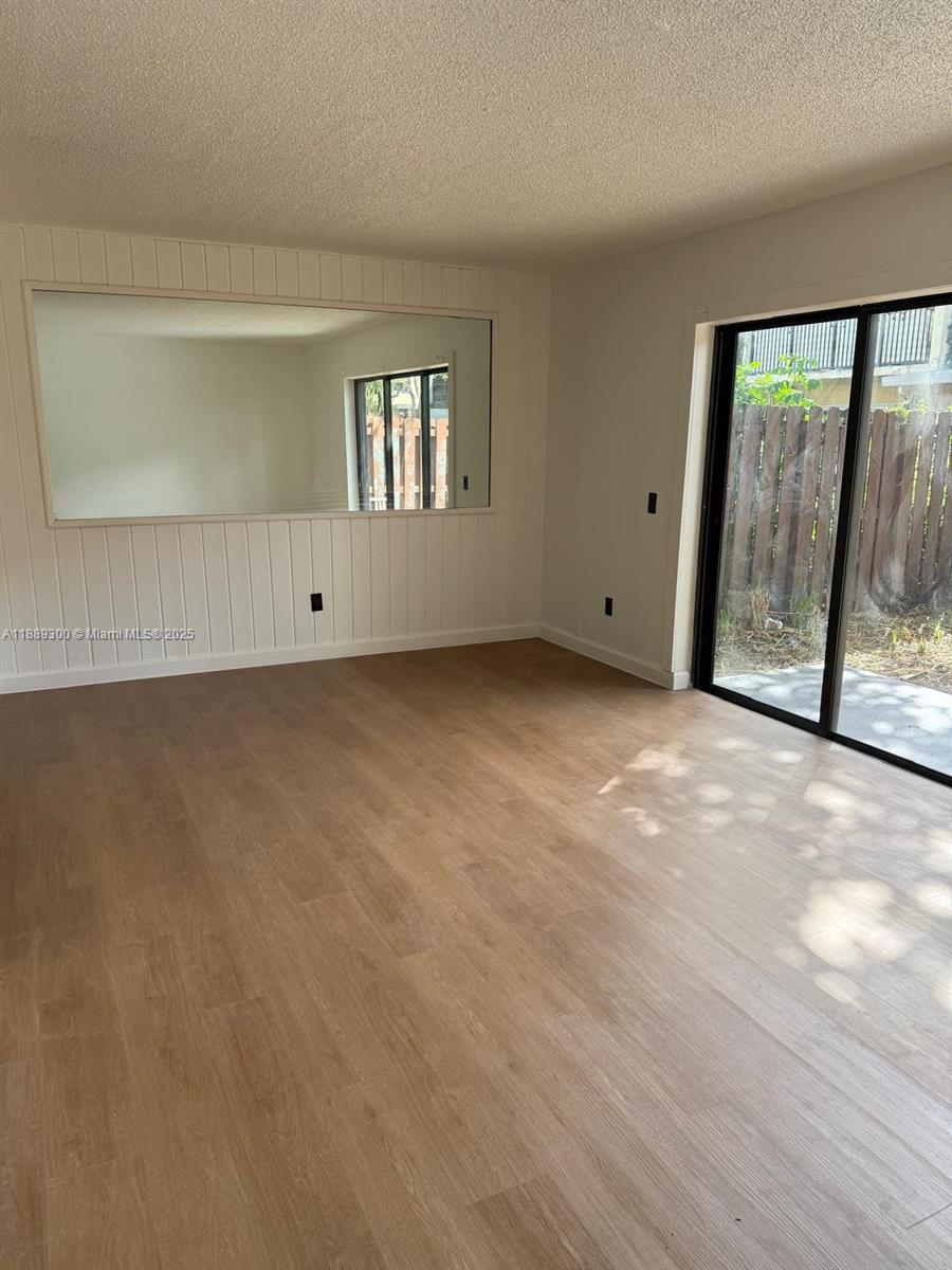 4163 Southwest 66th Terrace, Unit 108 Davie, FL 33314 - Photo 8 of 15 a view of an empty room with glass door