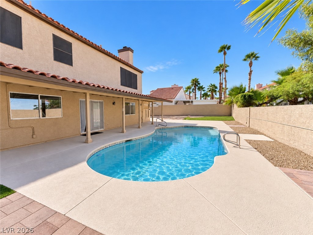 43 Bayridge Road Henderson, NV 89074 - Photo 11 of 47 A sparkling private pool highlights the concrete patio beneath a tiled-roof covered porch.