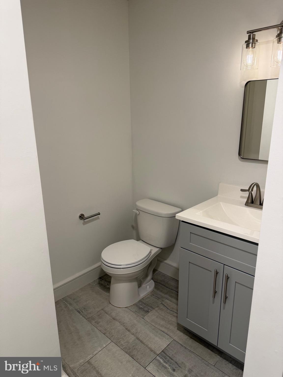 1087 Mt Tom Road, Unit 204 East Stroudsburg, PA 18301 - Photo 13 of 17 a bathroom with a toilet sink and mirror