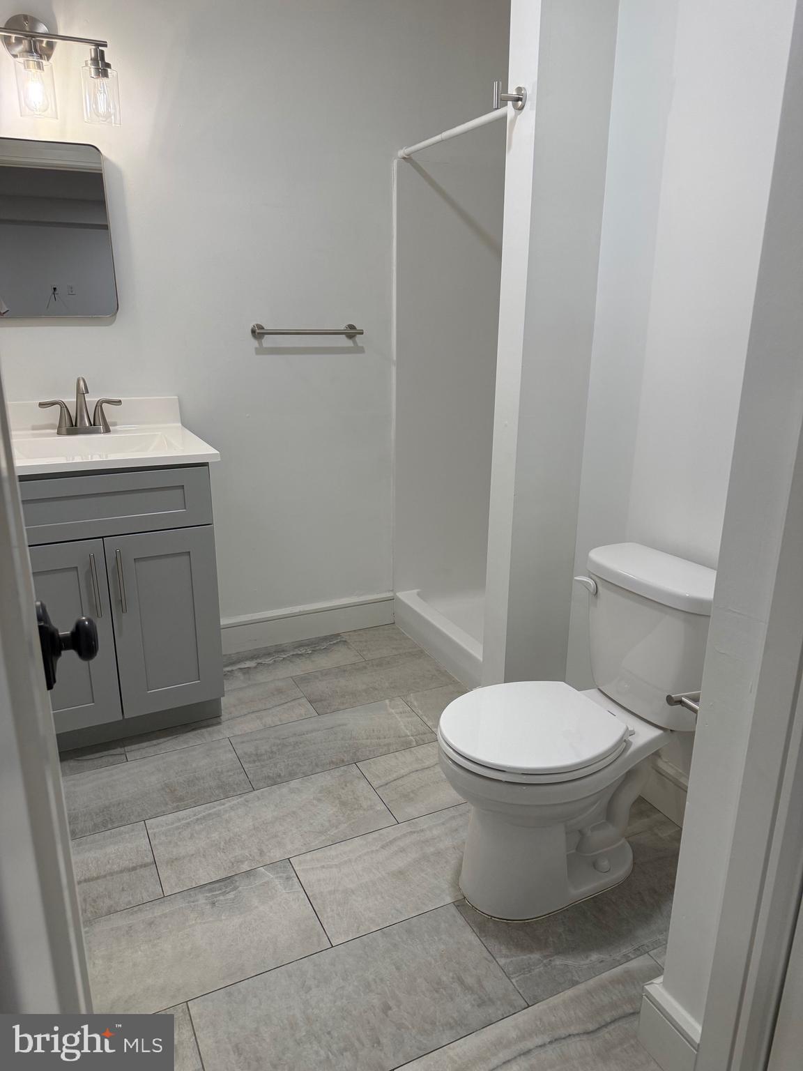 1087 Mt Tom Road, Unit 204 East Stroudsburg, PA 18301 - Photo 14 of 17 a bathroom with a sink toilet and vanity