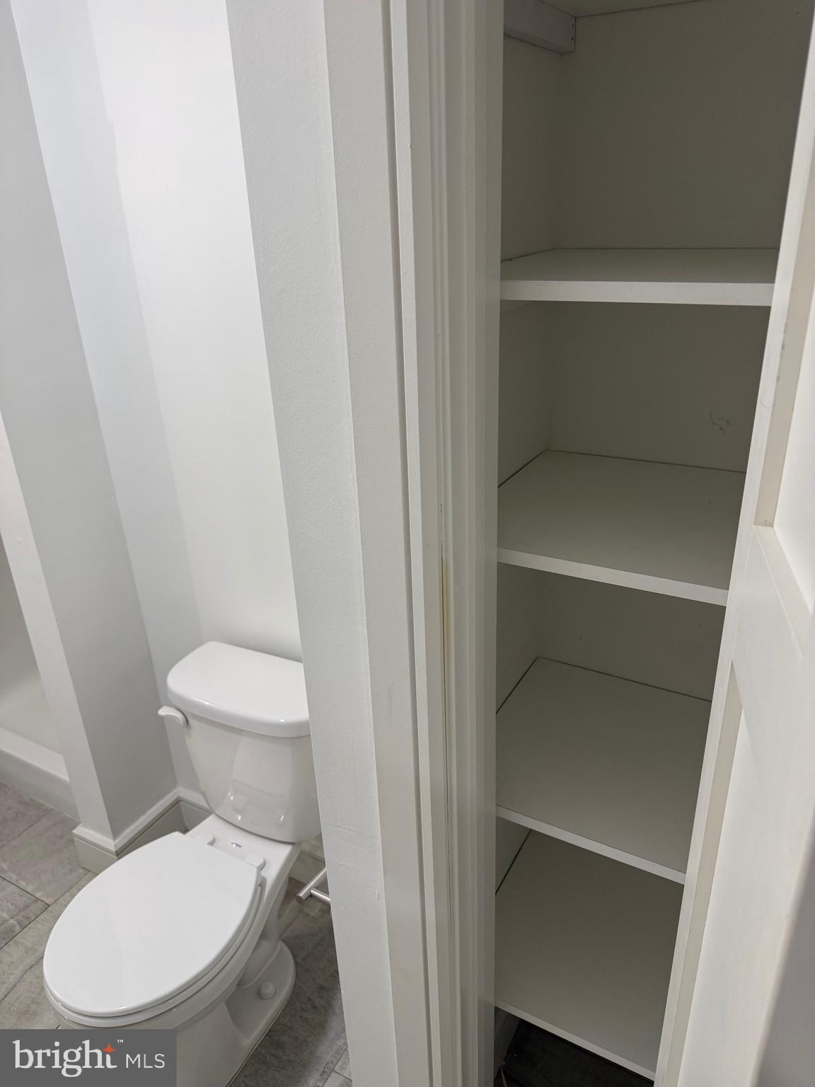 1087 Mt Tom Road, Unit 204 East Stroudsburg, PA 18301 - Photo 16 of 17 a white toilet sitting next to a bathroom sink