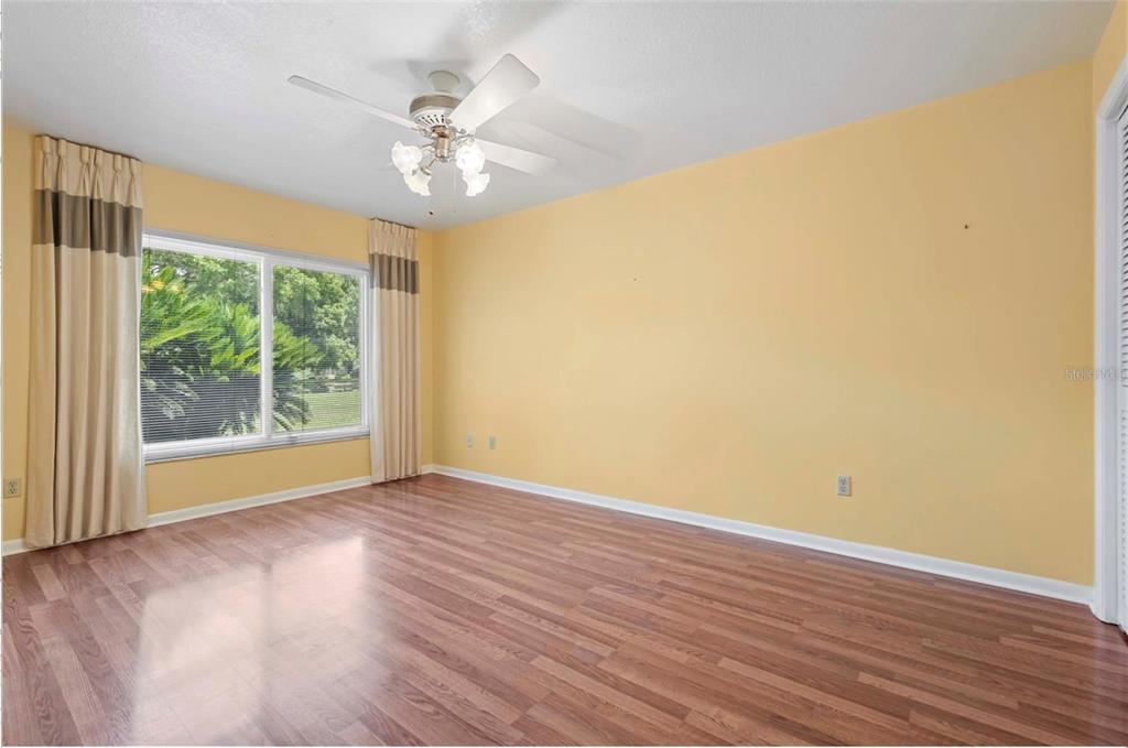 1255 Wisper Run Court Lutz, FL 33558 - Photo 15 of 25 a view of an empty room with wooden floor and a window