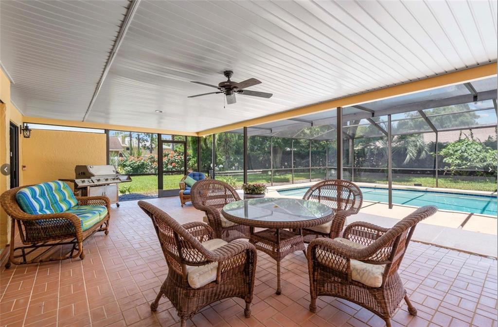 1255 Wisper Run Court Lutz, FL 33558 - Photo 19 of 25 a view of a patio with a dining table and chairs