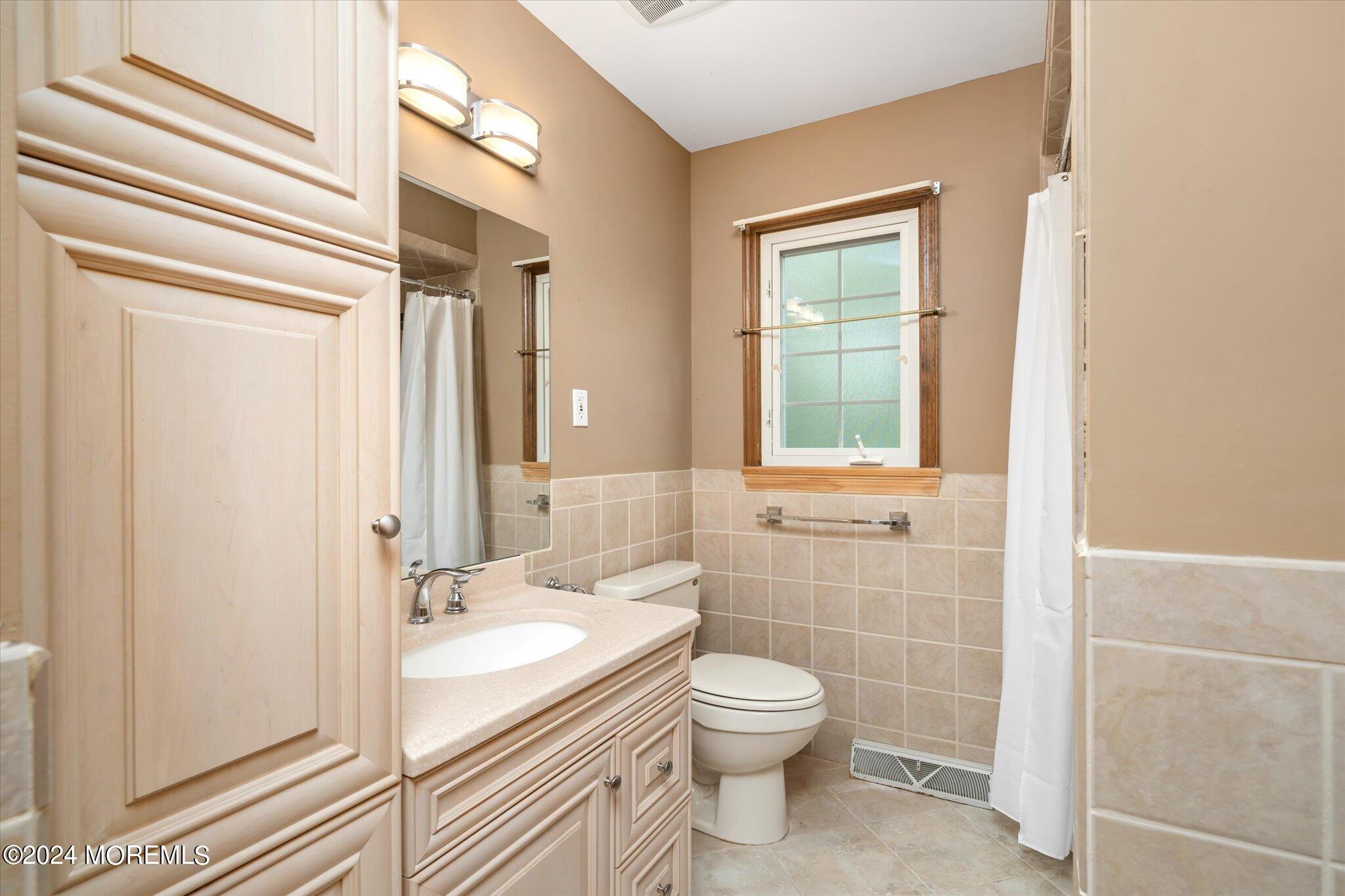 3720 River Road Point Pleasant, NJ 08742 - Photo 15 of 28 a bathroom with a granite countertop sink toilet and shower