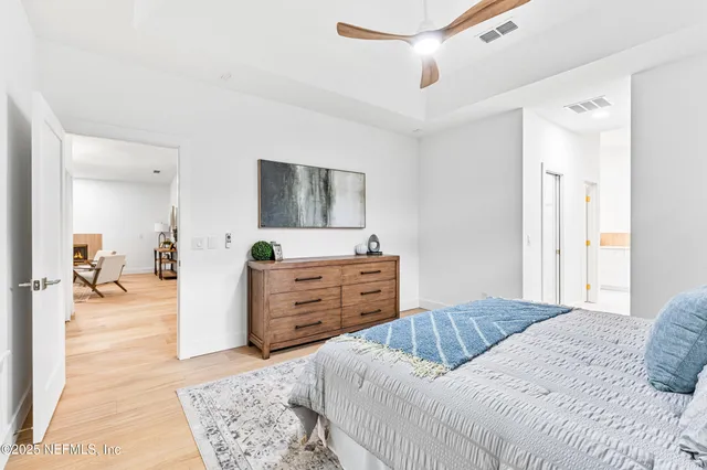 a bedroom with a bed and a dresser in it