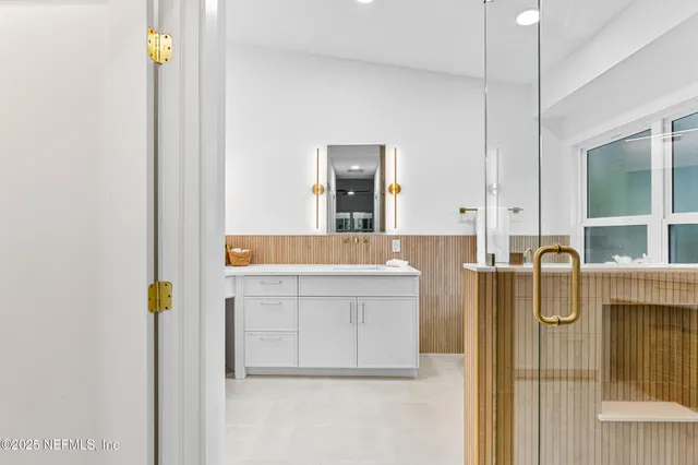 a bathroom with a bathtub sink and mirror
