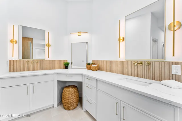 a utility room with a sink and mirror