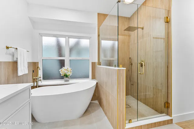 a bathroom with a bathtub and shower