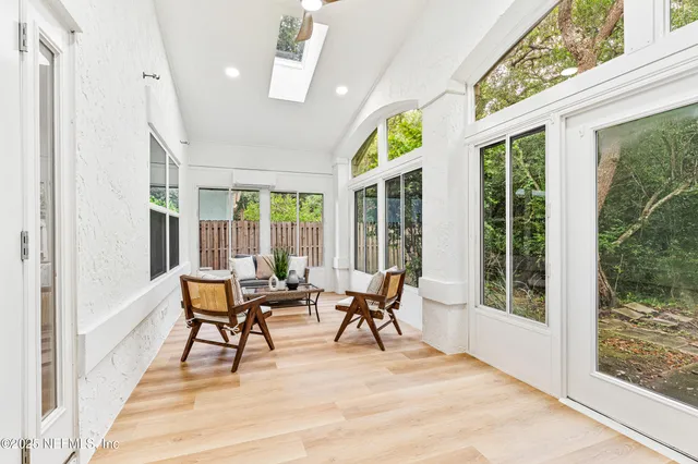 a dining room with furniture and wooden floor