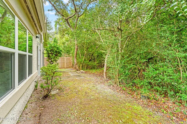 a yellow house with trees in front of it