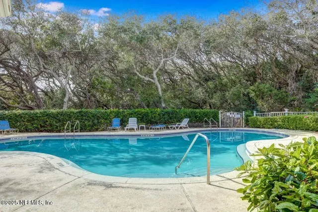 a view of a swimming pool with a yard