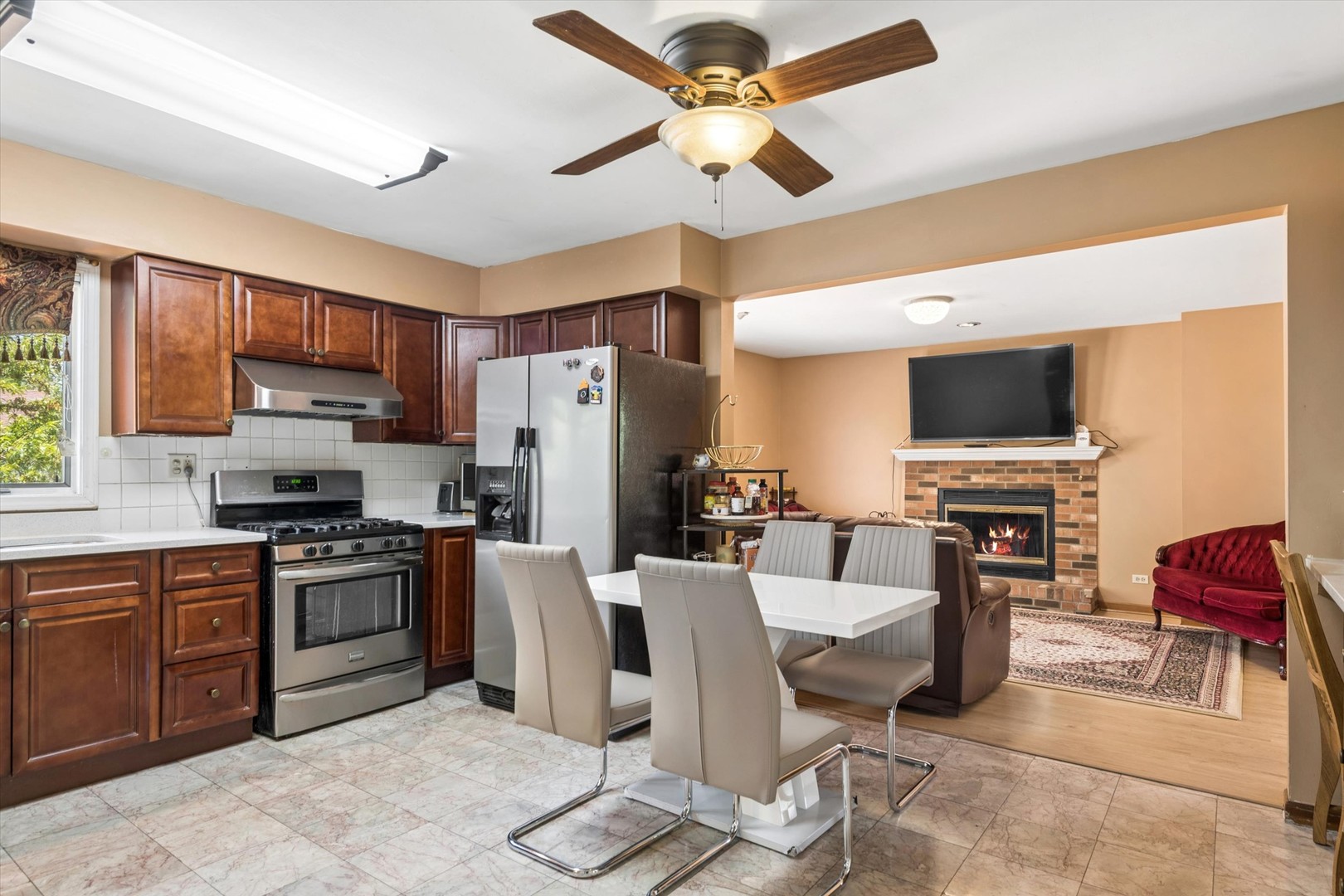 2142 North Summit Street Wheaton, IL 60187 - Photo 11 of 35 a living room with stainless steel appliances furniture a fireplace and a flat screen tv