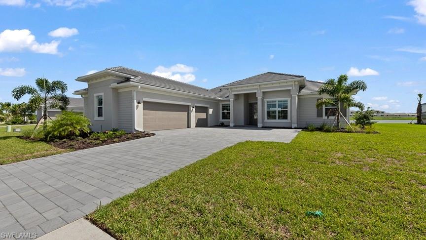 5406 Ternberry Road Ave Maria, FL 34142 - Photo 1 of 45 a front view of a house with garden