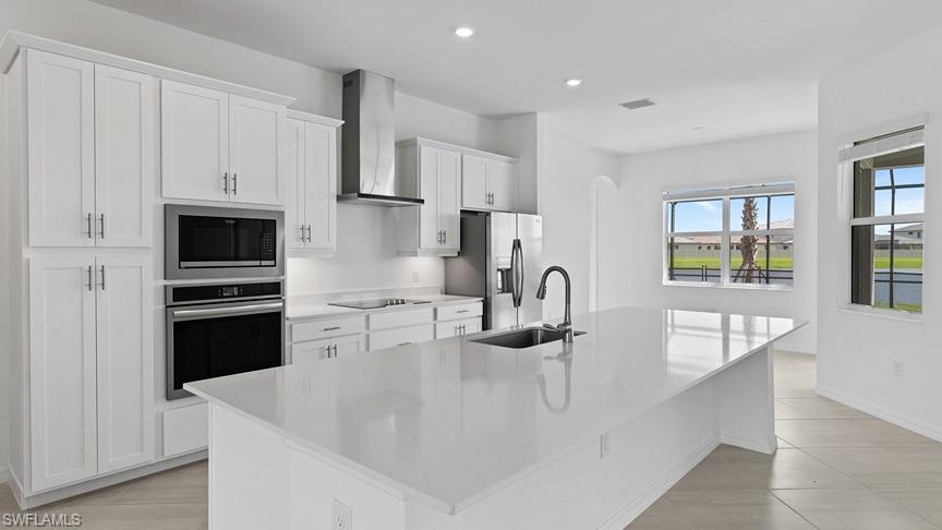 5406 Ternberry Road Ave Maria, FL 34142 - Photo 13 of 45 a kitchen with stainless steel appliances a sink a stove and a refrigerator