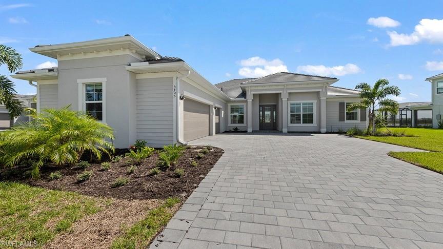 5406 Ternberry Road Ave Maria, FL 34142 - Photo 3 of 45 a view of a white house with a yard and potted plants