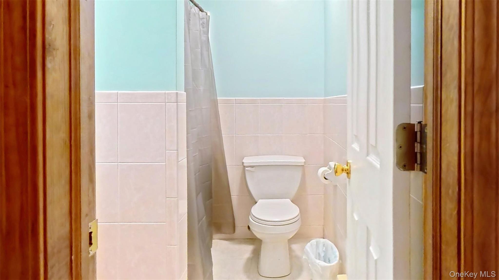 125 White Bridge Road Middletown, NY 10940 - Photo 21 of 43 Full bathroom featuring tile walls, curtained shower, and tile patterned flooring