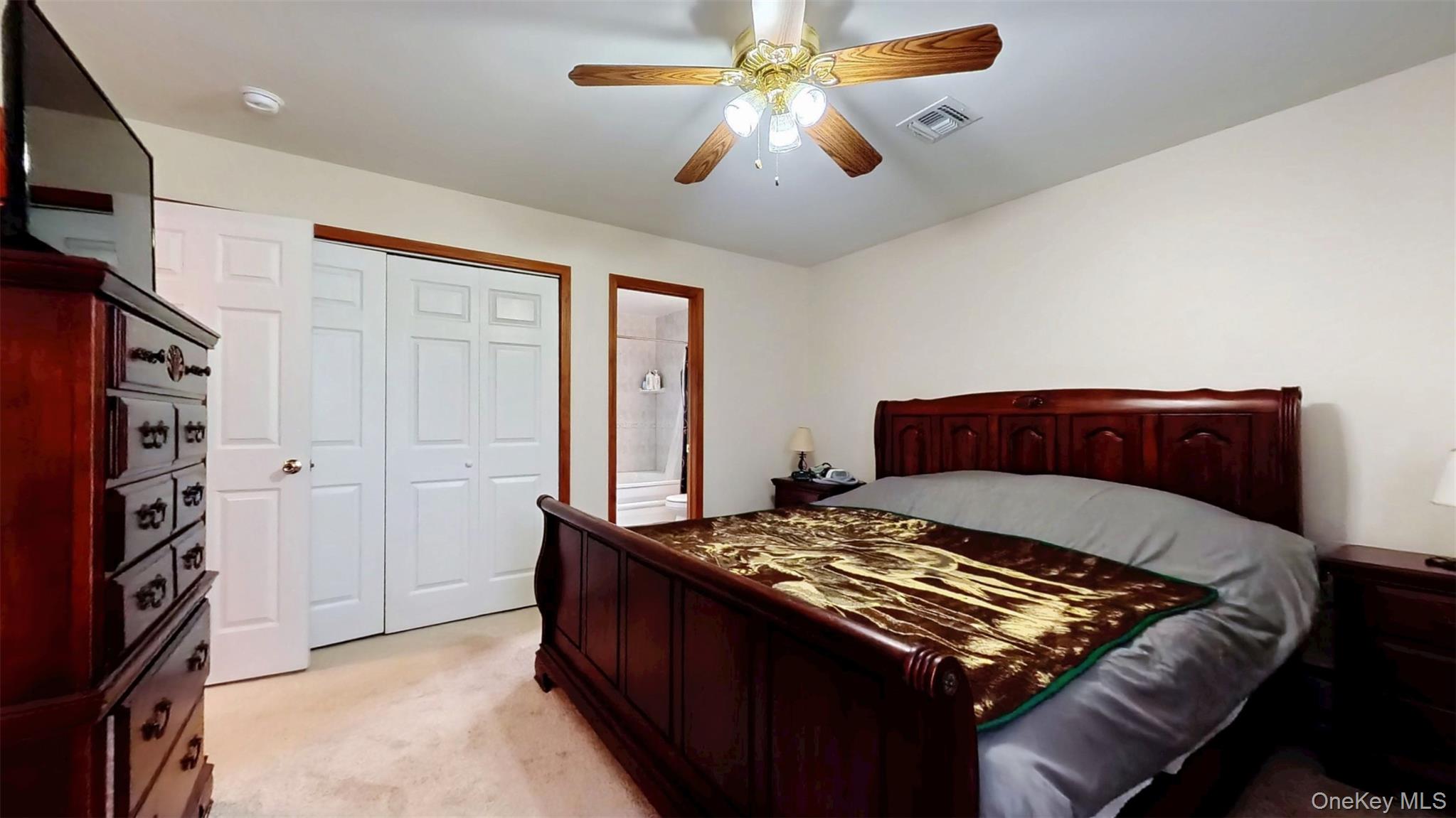 125 White Bridge Road Middletown, NY 10940 - Photo 25 of 43 Bedroom with light colored carpet, a closet, ceiling fan, and ensuite bath