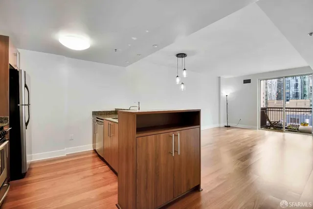 a view of a kitchen with a sink and a refrigerator