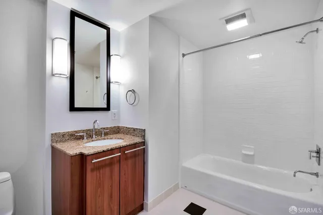 a bathroom with a tub sink and mirror