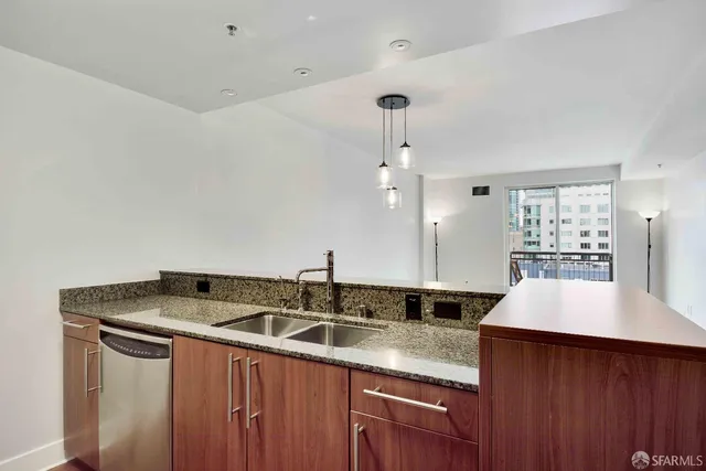 a kitchen with a sink a counter space and cabinets