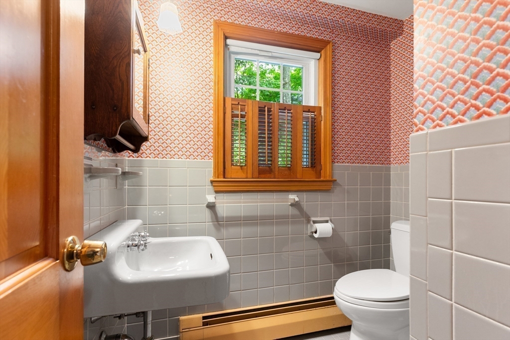 11 Tower Road Lexington, MA 02421 - Photo 12 of 33 a bathroom with a sink a toilet and a mirror
