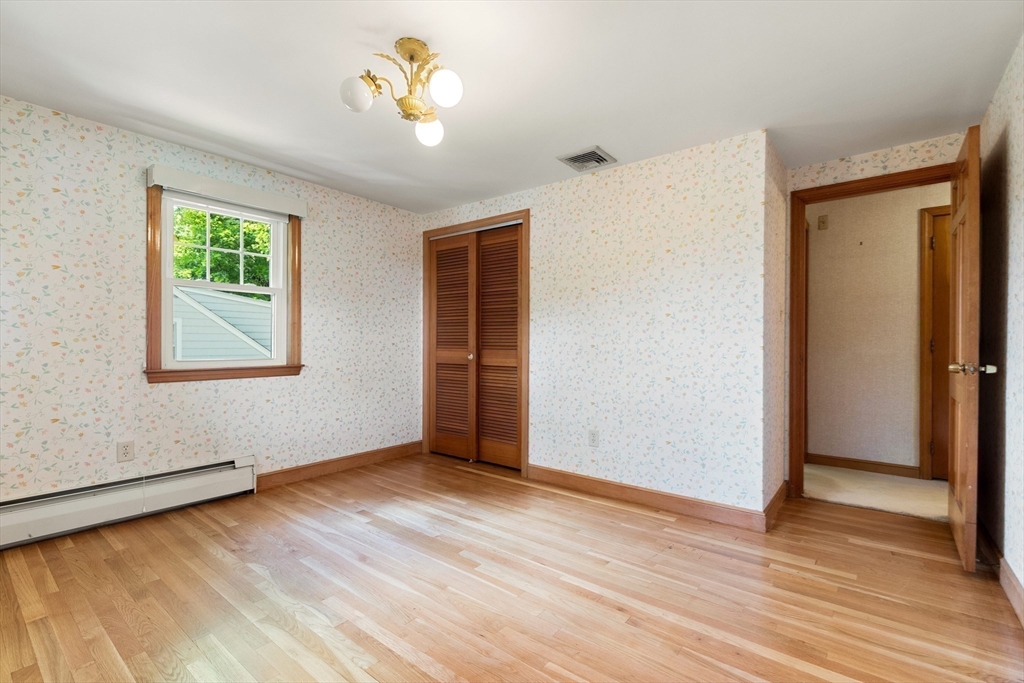 11 Tower Road Lexington, MA 02421 - Photo 16 of 33 a view of an empty room with wooden floor and a window