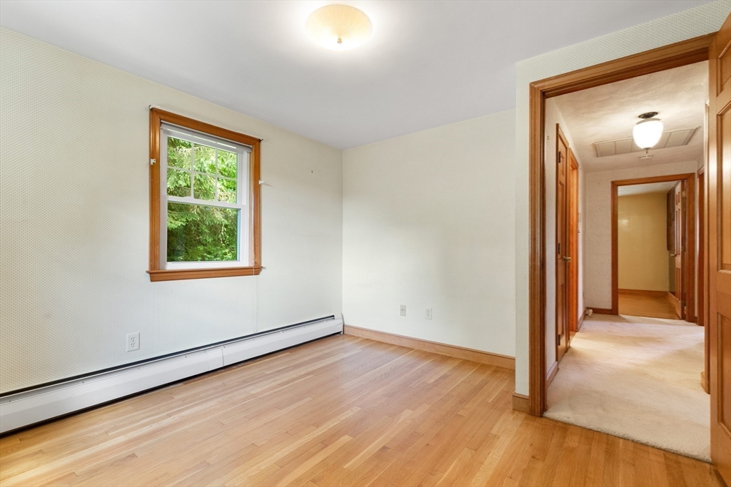 11 Tower Road Lexington, MA 02421 - Photo 19 of 33 an empty room with wooden floor and windows