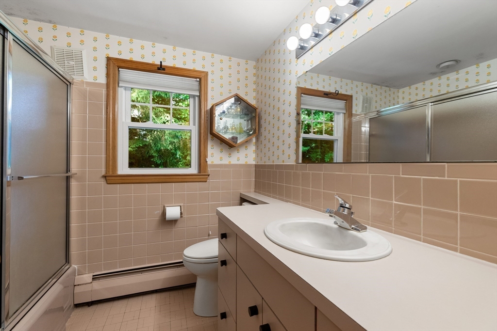 11 Tower Road Lexington, MA 02421 - Photo 20 of 33 a bathroom with a sink toilet and a mirror
