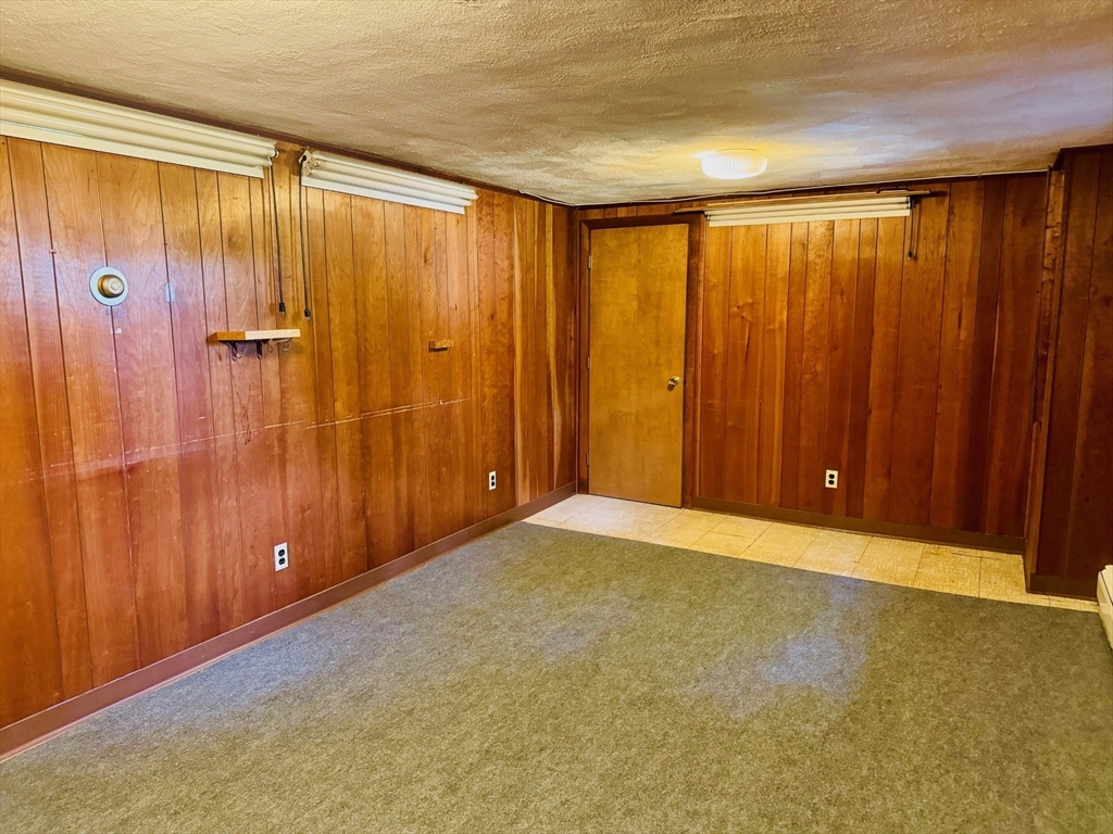 11 Tower Road Lexington, MA 02421 - Photo 26 of 33 a view of an empty room with wooden walls