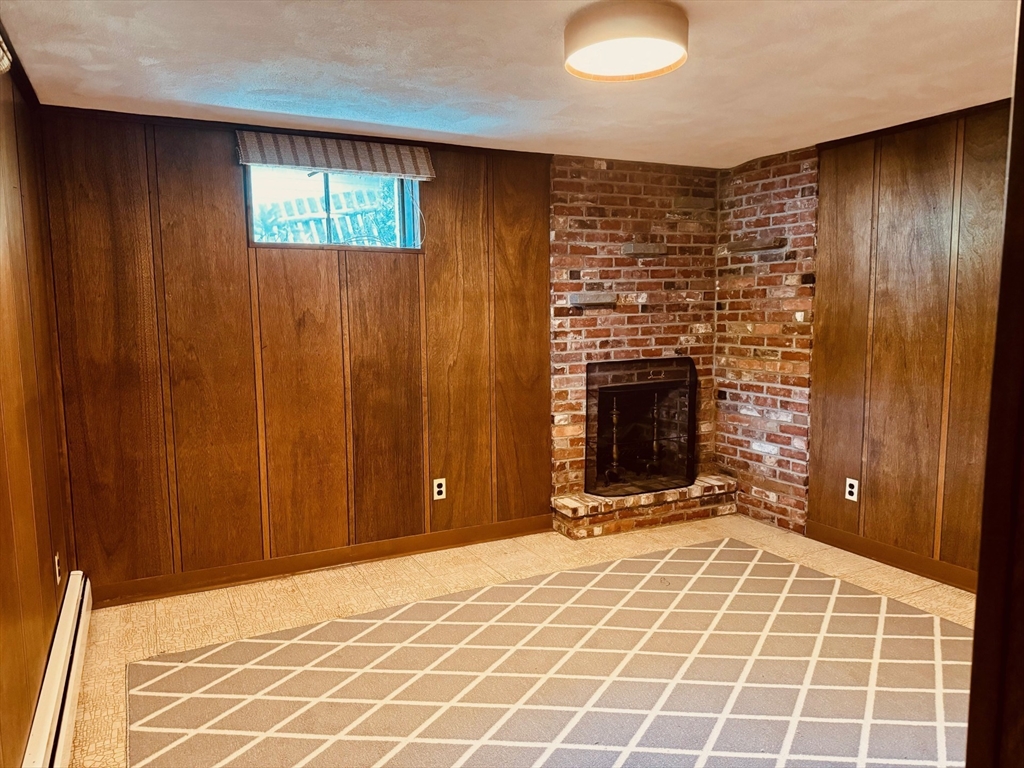 11 Tower Road Lexington, MA 02421 - Photo 27 of 33 a view of an empty room with a fireplace