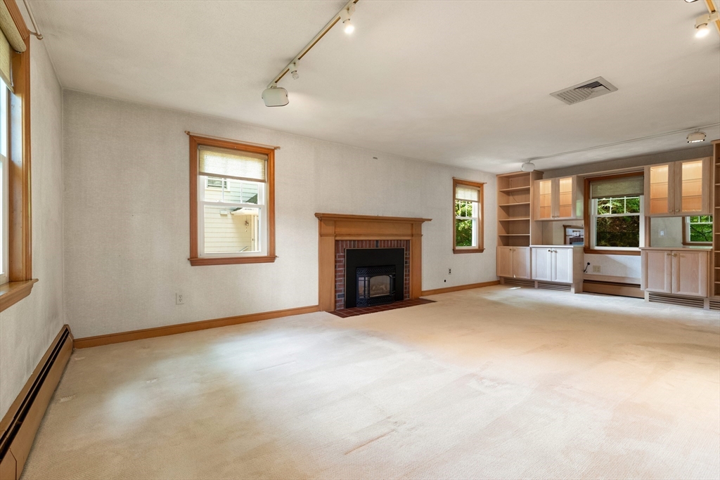 11 Tower Road Lexington, MA 02421 - Photo 5 of 33 an empty room with windows and fireplace