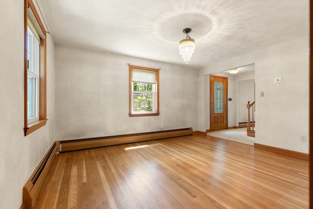 11 Tower Road Lexington, MA 02421 - Photo 8 of 33 a view of an empty room with wooden floor and a window