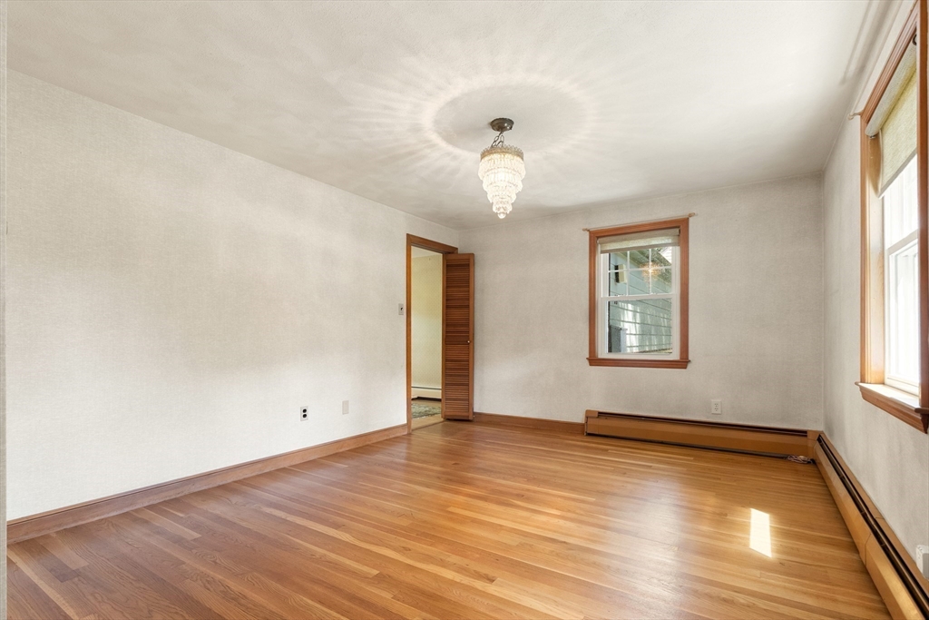 11 Tower Road Lexington, MA 02421 - Photo 9 of 33 an empty room with wooden floor and windows