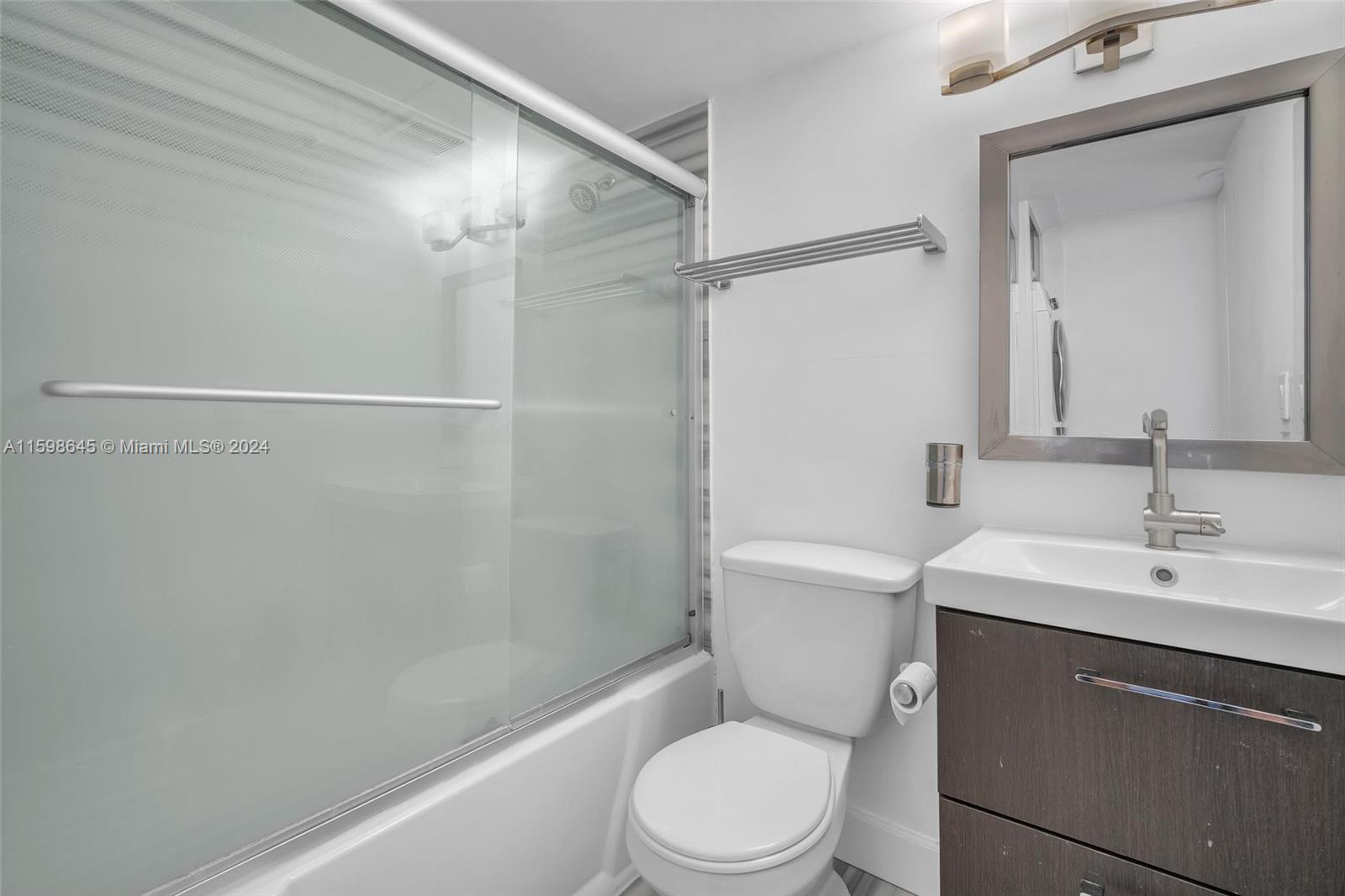 1500 Bay Road, Unit 608S Miami Beach, FL 33139 - Photo 7 of 8 a bathroom with a sink a toilet and shower