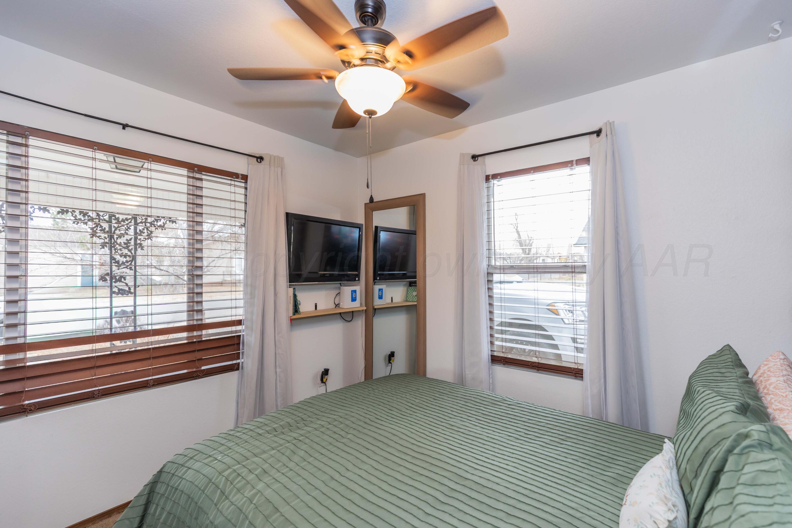 91 North Alabama Street Amarillo, TX 79106 - Photo 13 of 28 a bedroom with a large bed and a tv