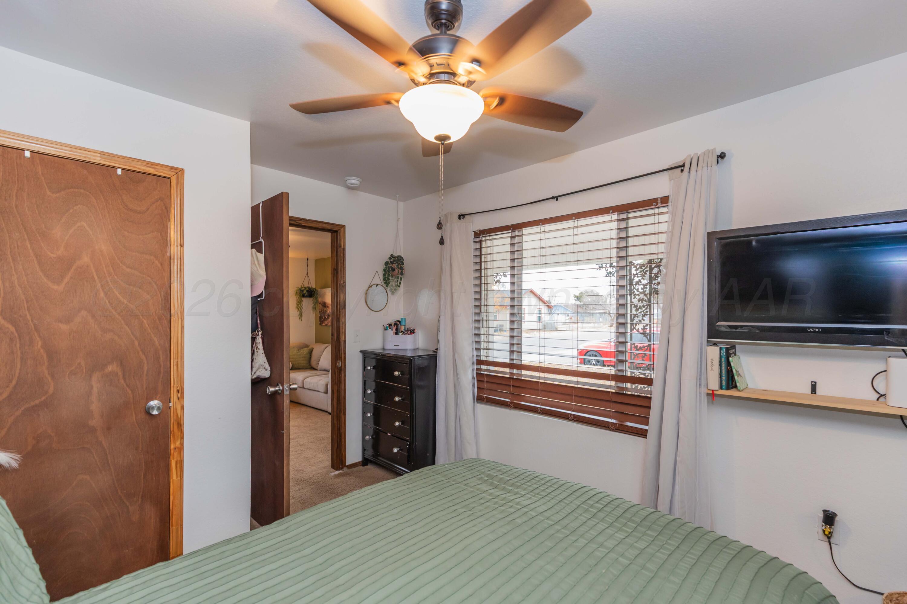 91 North Alabama Street Amarillo, TX 79106 - Photo 14 of 28 a bedroom with a bed and a flat screen tv