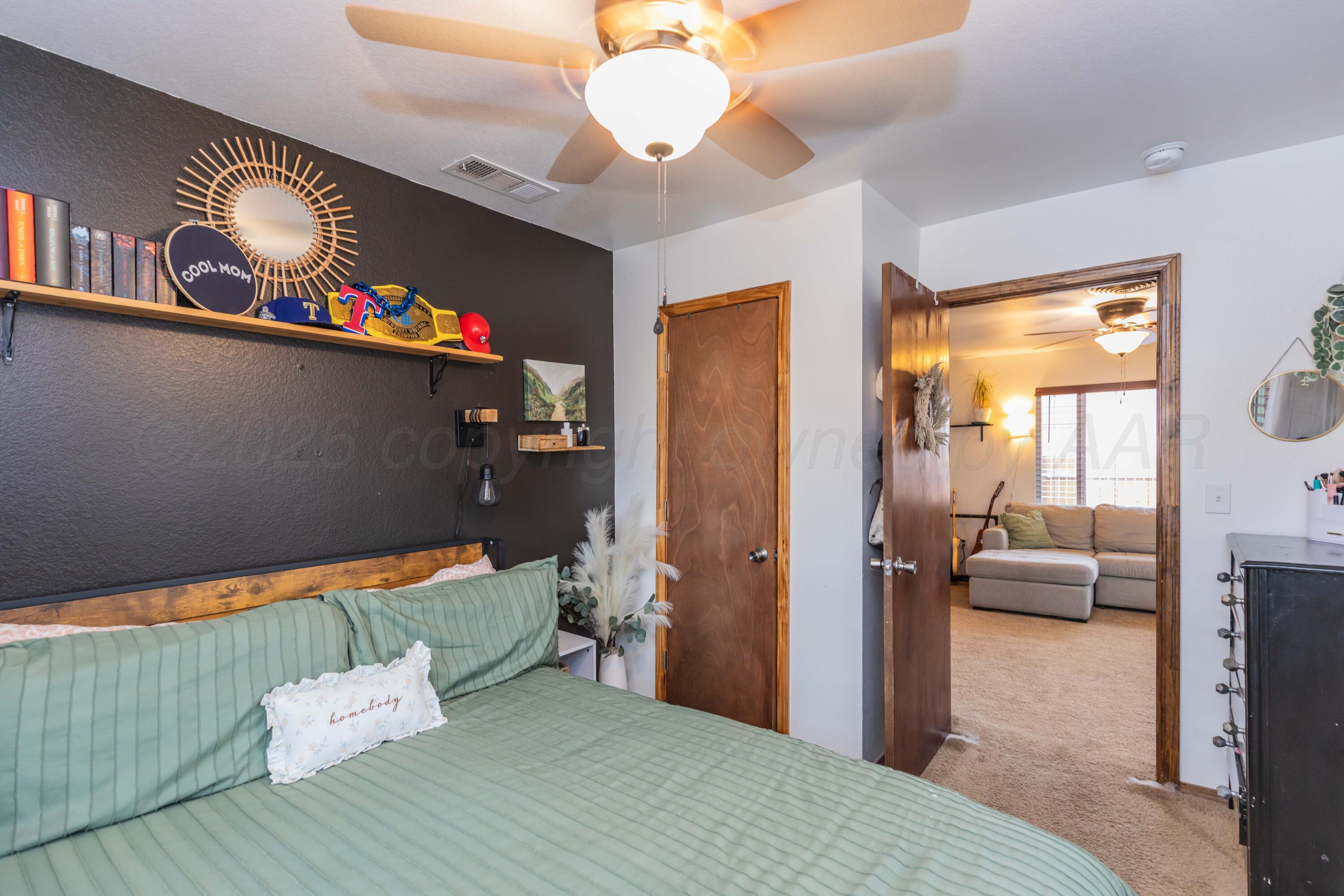 91 North Alabama Street Amarillo, TX 79106 - Photo 15 of 28 a bedroom with a bed and a chandelier