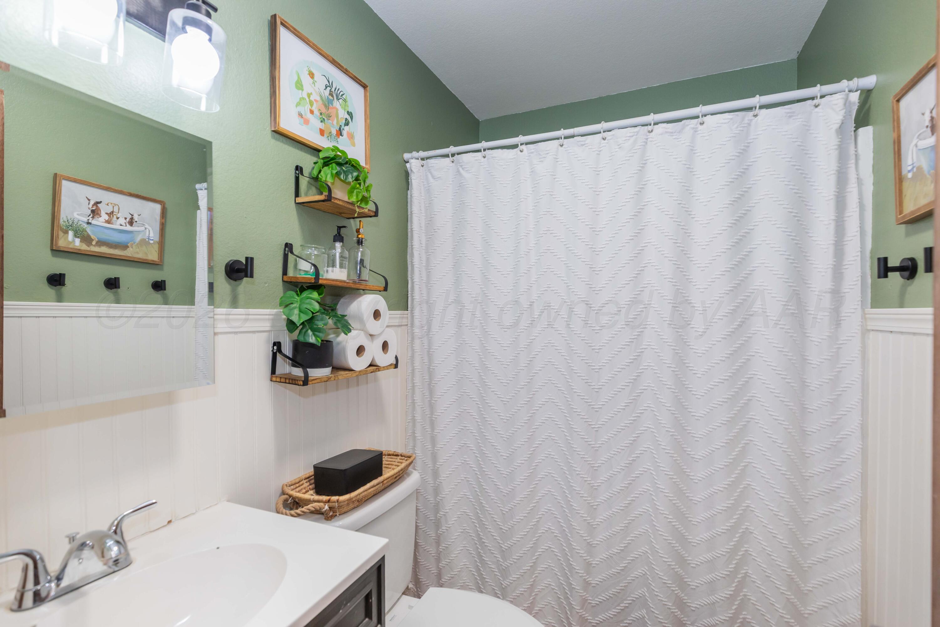 91 North Alabama Street Amarillo, TX 79106 - Photo 16 of 28 a bathroom with a sink mirror and toilet