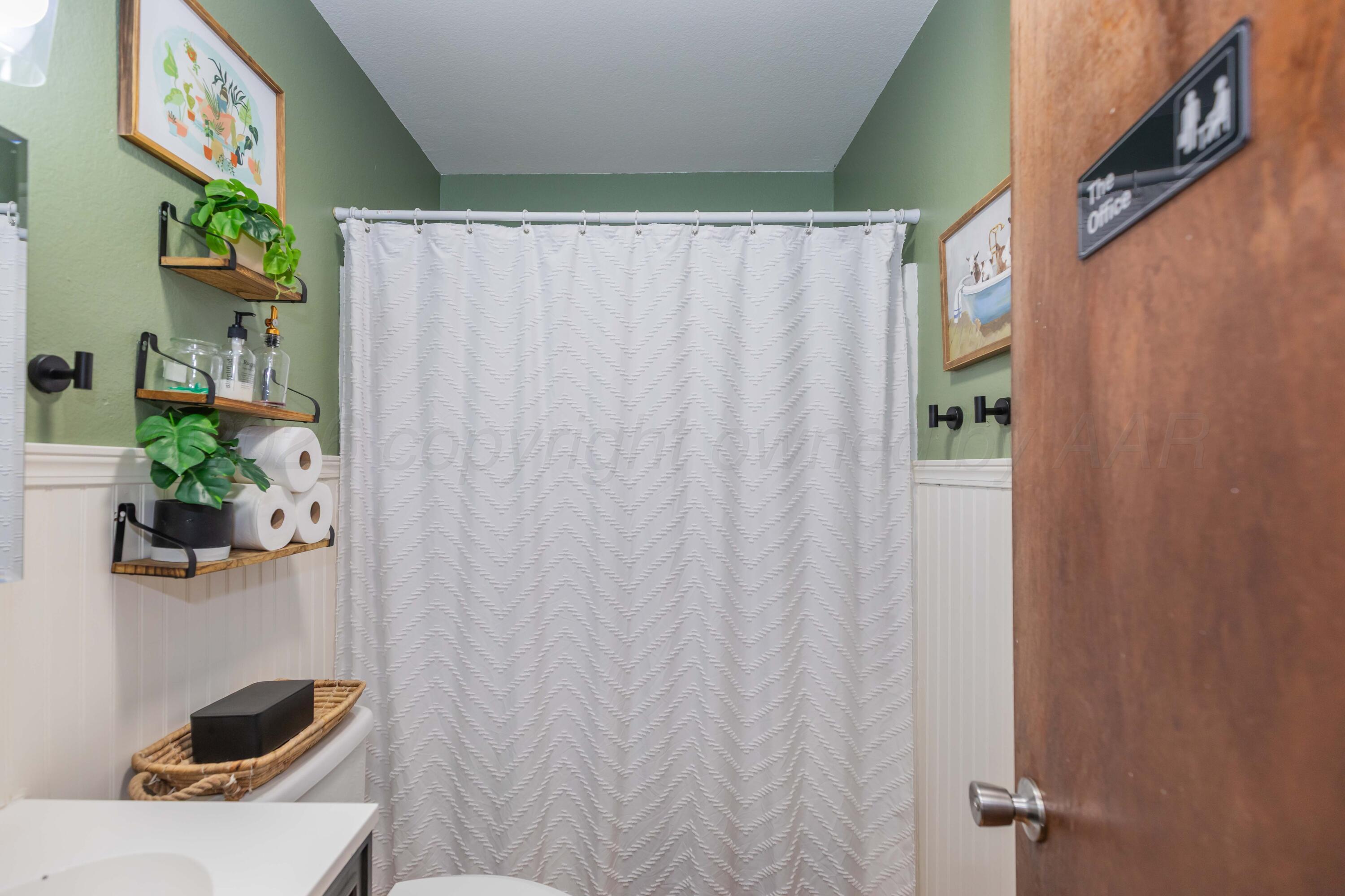 91 North Alabama Street Amarillo, TX 79106 - Photo 17 of 28 a bathroom with a shower curtain and sink
