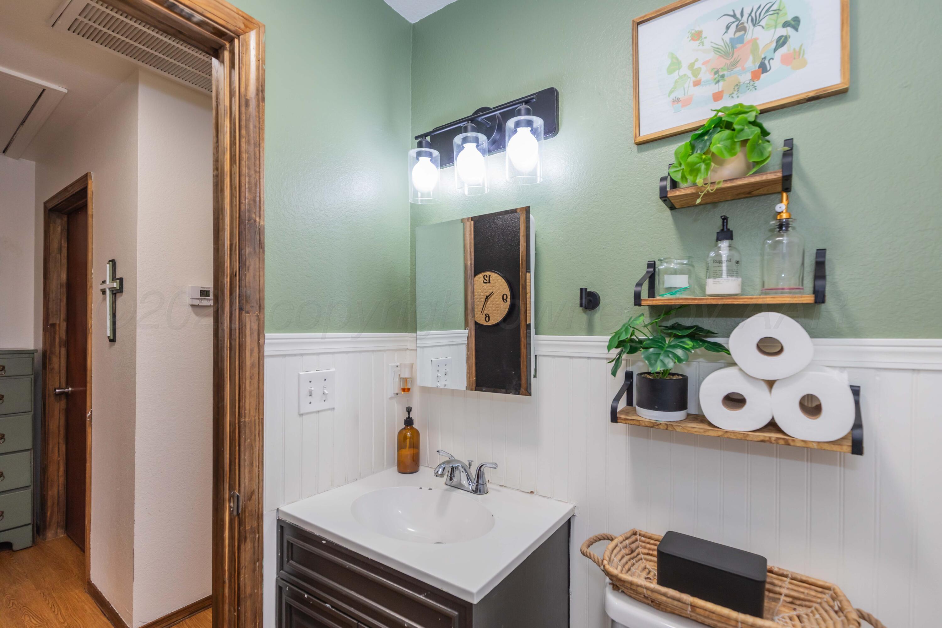 91 North Alabama Street Amarillo, TX 79106 - Photo 18 of 28 a bathroom with a sink mirror and vanity