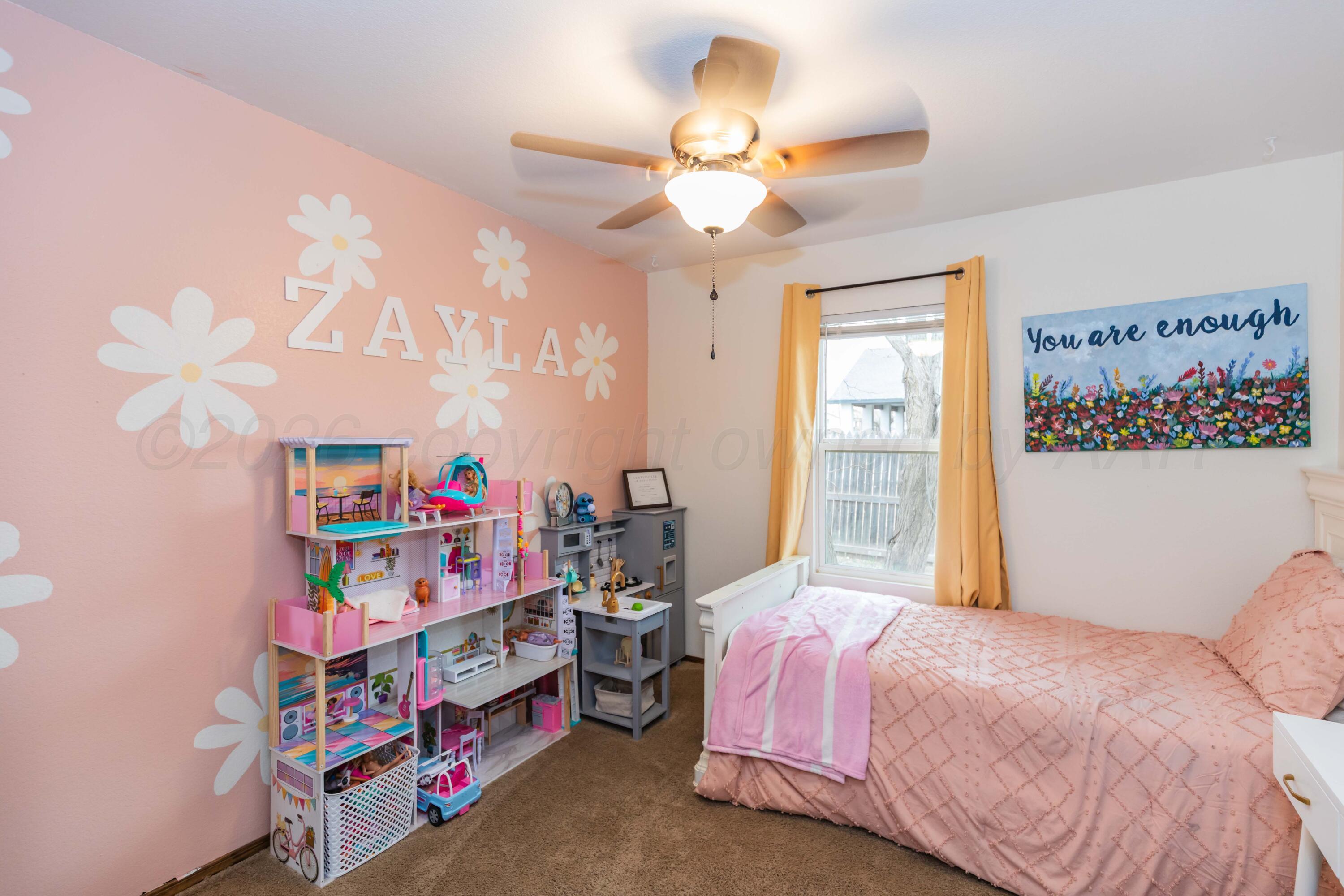 91 North Alabama Street Amarillo, TX 79106 - Photo 21 of 28 a bedroom with a bed and a chandelier