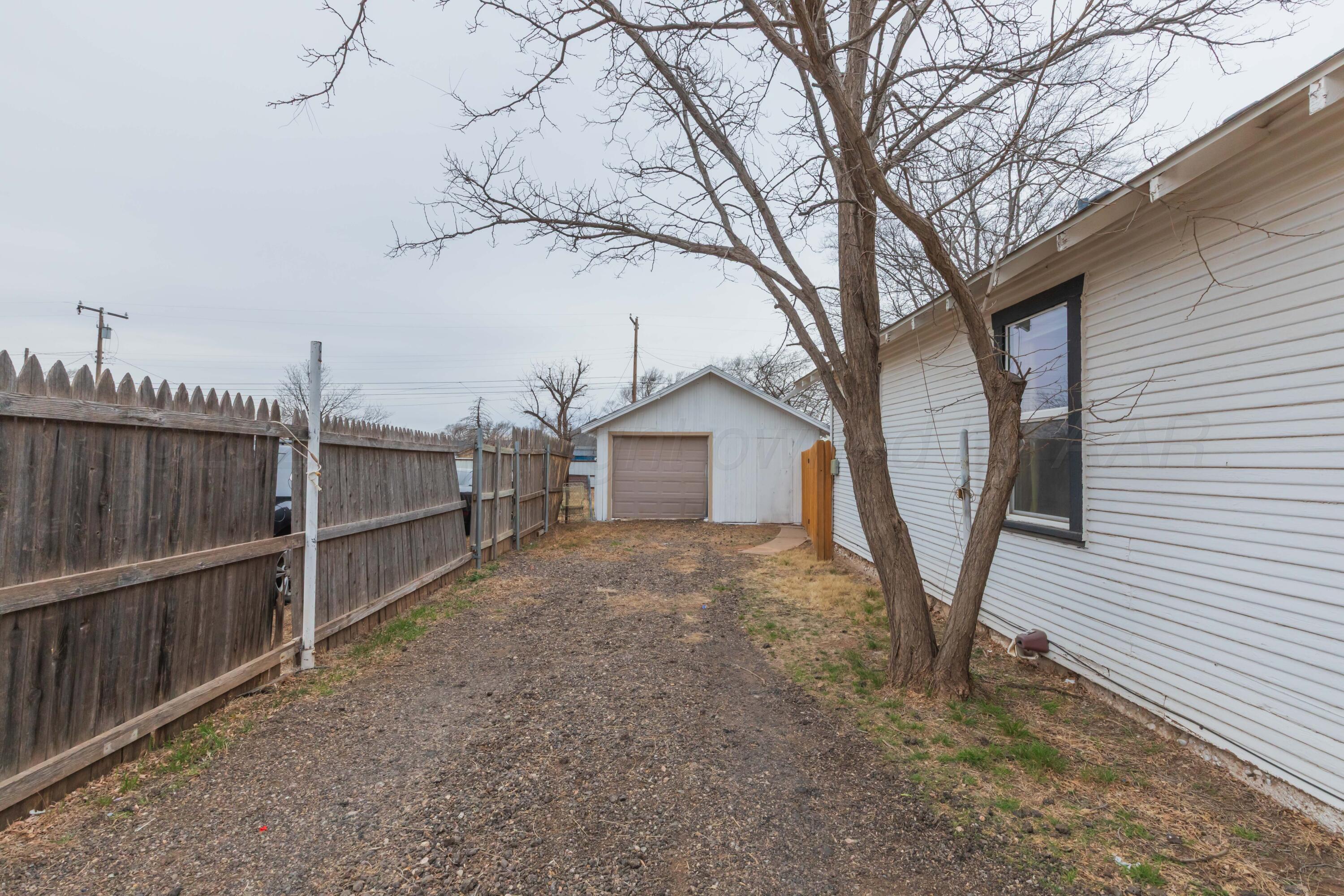 91 North Alabama Street Amarillo, TX 79106 - Photo 24 of 28 a view of backyard with wooden fence and large trees