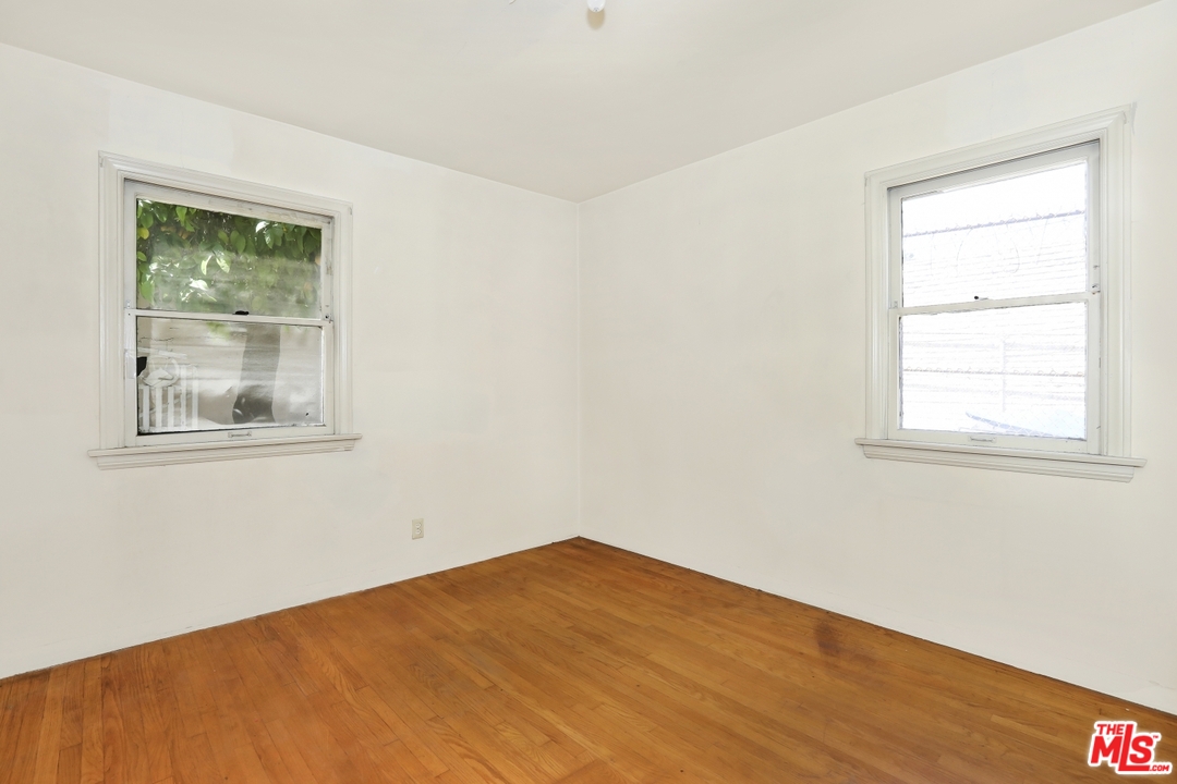 4053 Verdugo Road Los Angeles, CA 90065 - Photo 11 of 45 a view of an empty room with wooden floor and a window