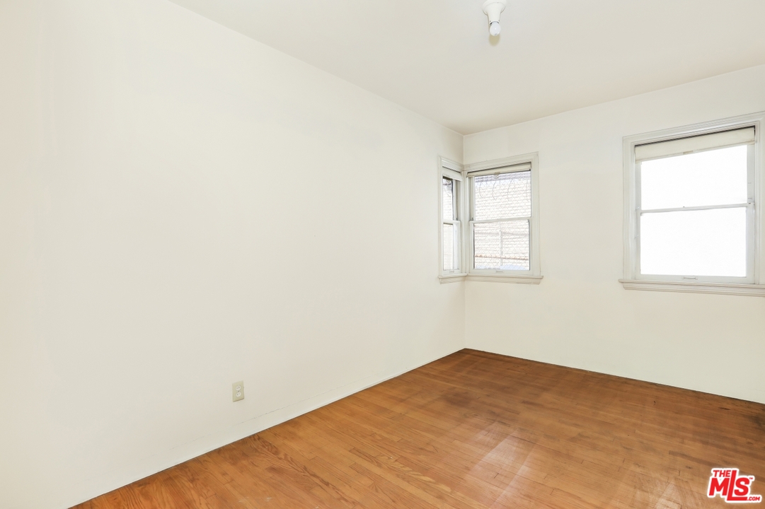 4053 Verdugo Road Los Angeles, CA 90065 - Photo 16 of 45 an empty room with wooden floor and windows