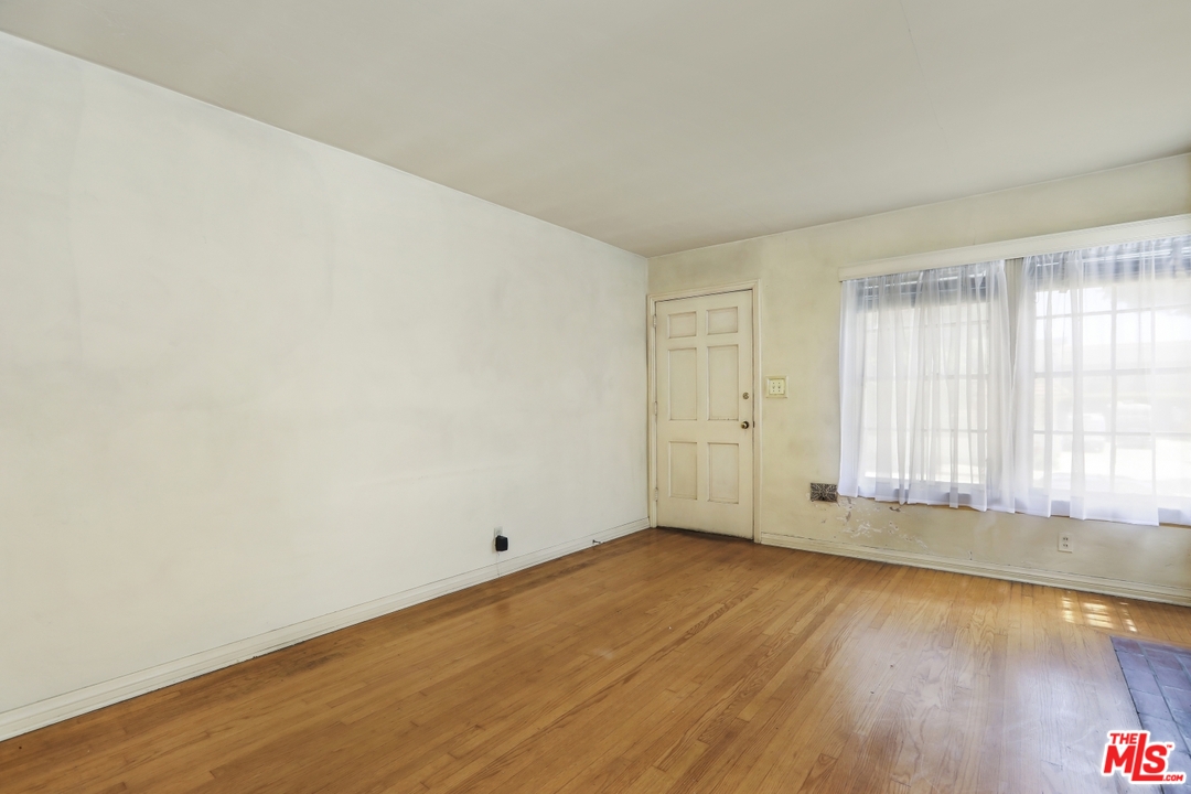 4053 Verdugo Road Los Angeles, CA 90065 - Photo 17 of 45 an empty room with wooden floor and windows
