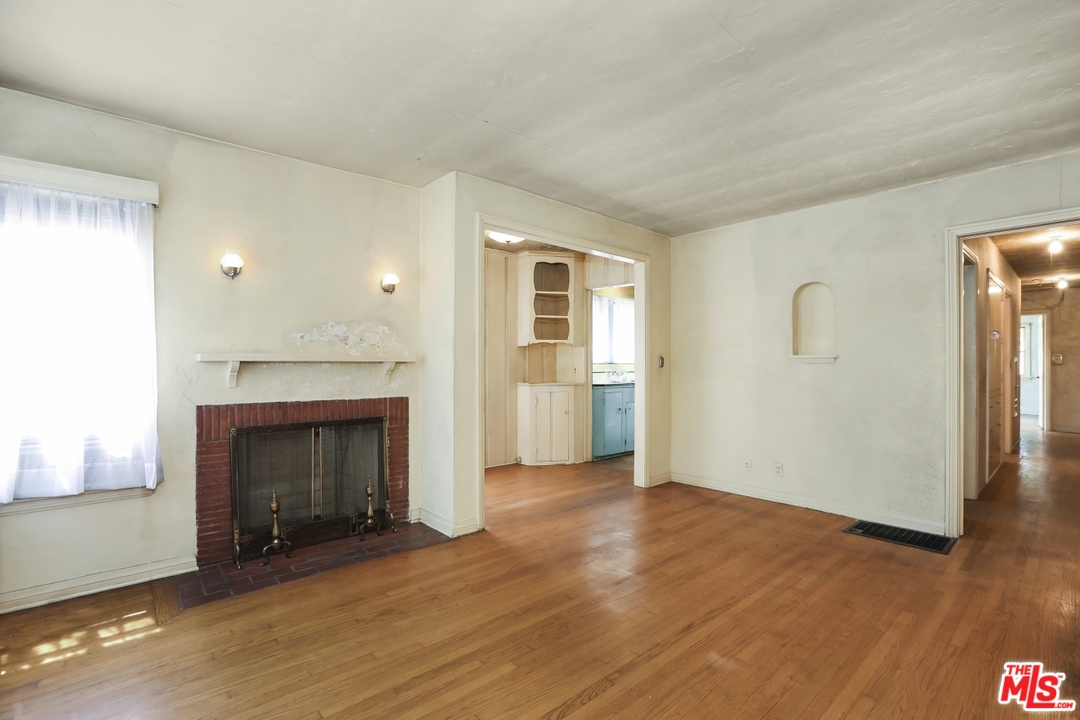 4053 Verdugo Road Los Angeles, CA 90065 - Photo 18 of 45 an empty room with wooden floor fireplace and windows