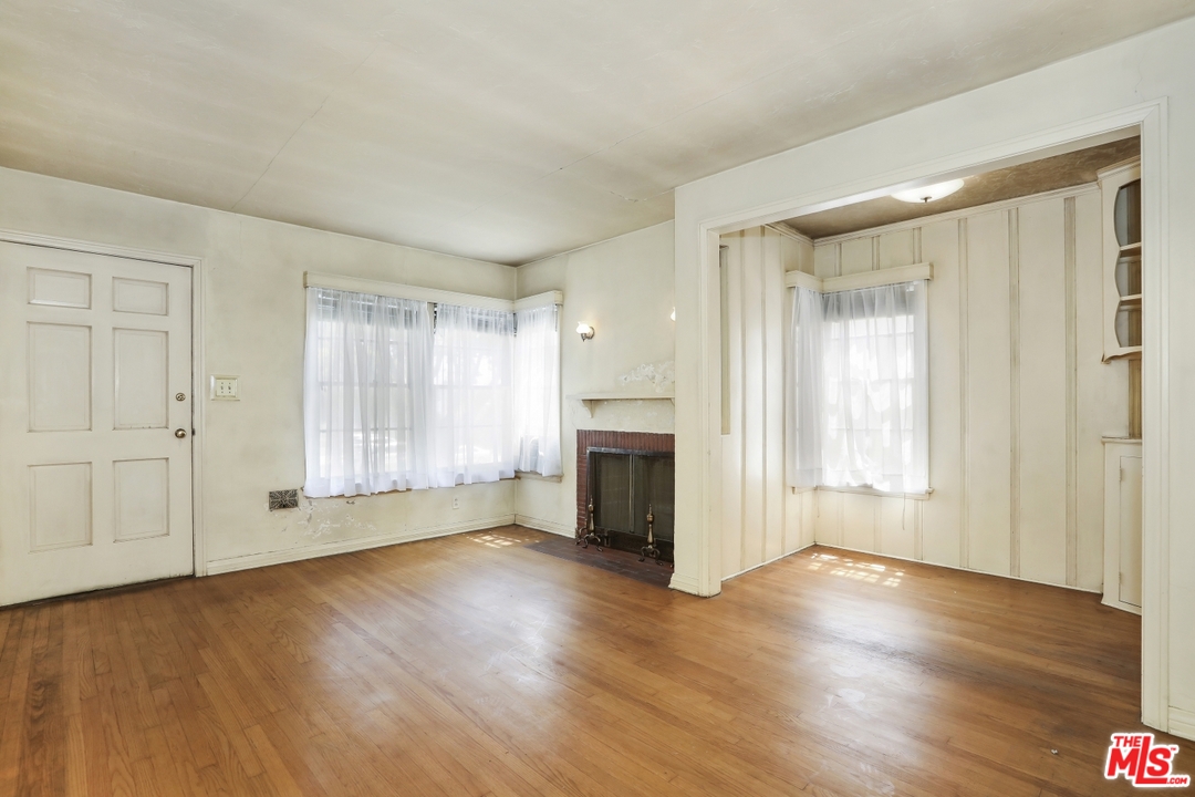 4053 Verdugo Road Los Angeles, CA 90065 - Photo 19 of 45 an empty room with wooden floor cabinet and windows