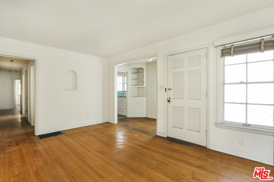4053 Verdugo Road Los Angeles, CA 90065 - Photo 3 of 45 an empty room with wooden floor and windows